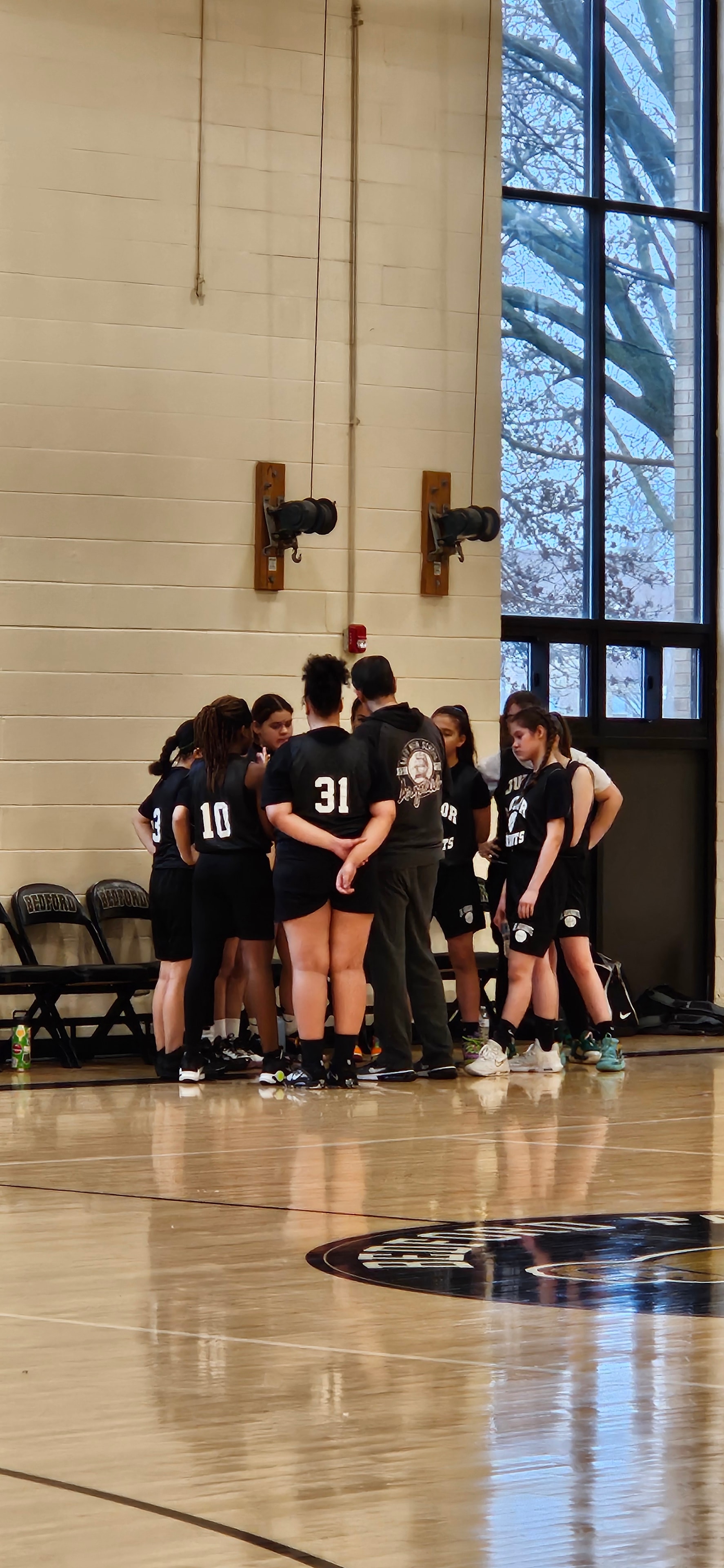 2024 Junior Argonauts team lined up with medals on court