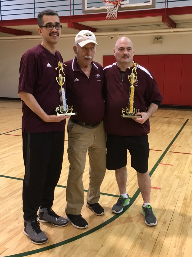 Coaches holding 2017 championship trophies