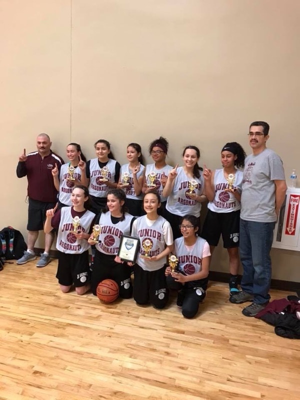 Junior Argonauts team celebrating championship with number one sign