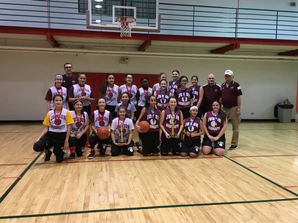 Junior Argonauts team with trophies on the gym floor